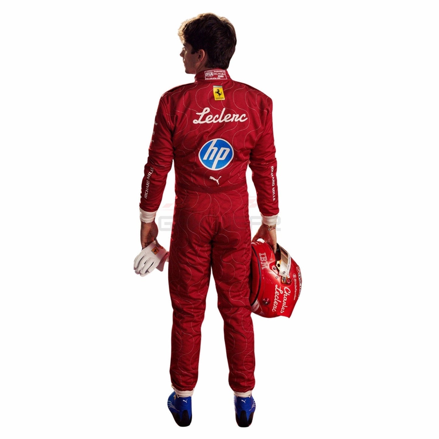 Charles Leclerc wearing a red 2025 Ferrari Monza GP F1 racing suit with various logos, holding a helmet - GPX WEAR