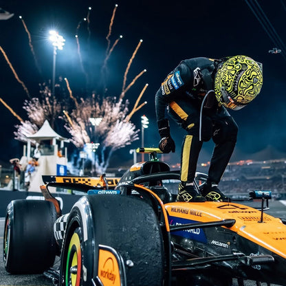 2025 Lando Norris Abu Dhabi GP celebrating on a Formula 1 car with fireworks 