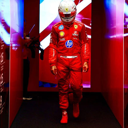 Lewis Hamilton wearing a red 2025 Ferrari Las Vegas GP F1 racing suit  with various sponsor logos in a red-themed room - GPX WEAR