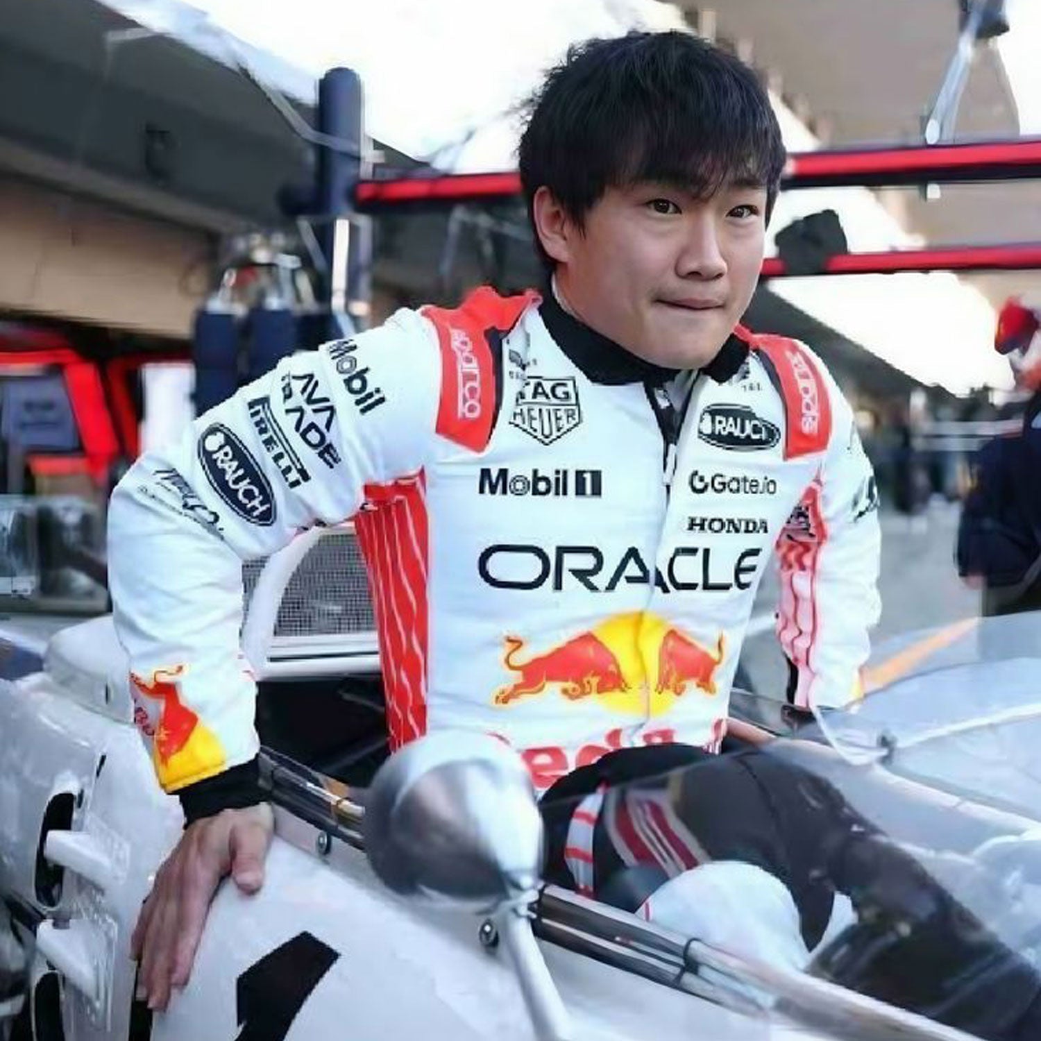 2025 Yuki Tsunoda Setting in a car wearing Japanese GP F1 Racing Suit Team Red Bull