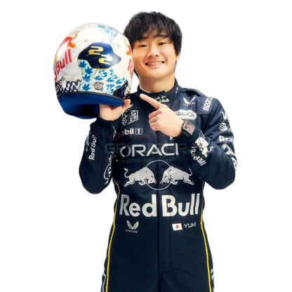 Yuki Tsunoda wearing a black 2025 Red Bull Las Vegas GP F1 racing suit, holding a helmet with Red Bull branding - GPX WEAR