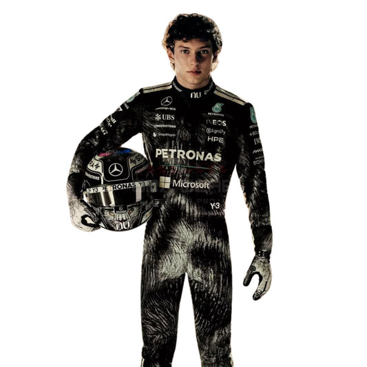 A Andrea Kimi Antonelli wearing a full Mercedes Petronas racing suit and holding a matching helmet, photographed against a plain white background.