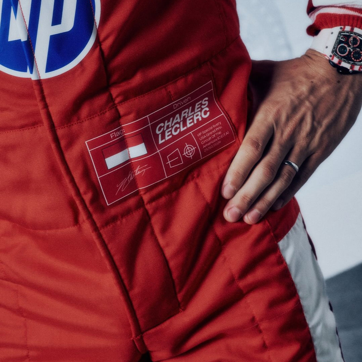 Charles Leclerc 2026 USGP Ferrari F1 racing suit with various sponsor logos - GPX WEAR