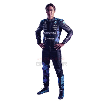 A George-Russell modeling a purple Mercedes racing suit with white sponsor logos, paired with bright racing shoes, against a plain white background.