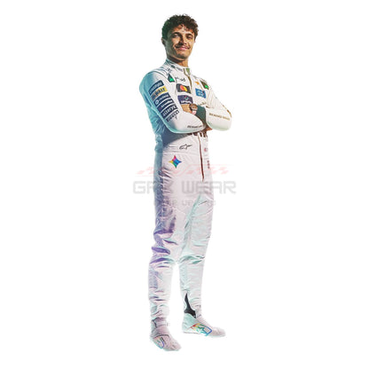 2026 Lando Norris Silverstone British GP wearing a white racing suit with multiple sponsor logos, standing with arms crossed against a plain white background.